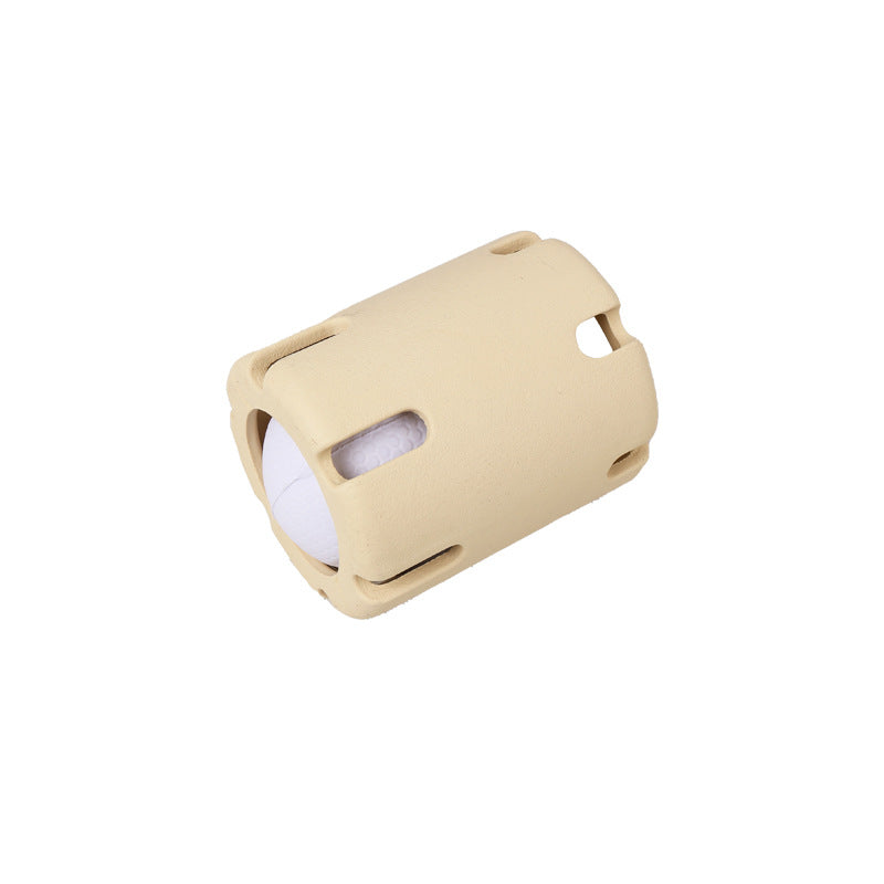 Sand slotted rubber dog ball cage holding a white textured ball