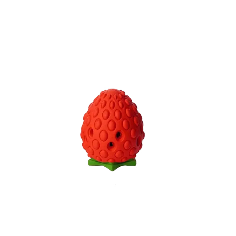Small red rubber strawberry dog treat toy with dimpled skin, green leaf base and kibble holes