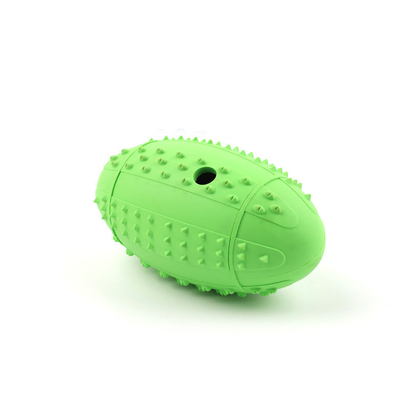 Lime green rubber rugby ball dog toy, nubbed all over, with the dispensing hole visible