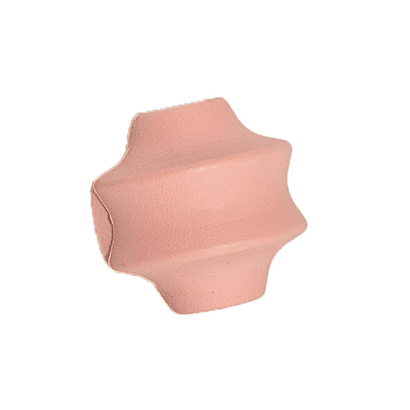 Pink natural rubber dog treat ball with ridged star profile and treat opening