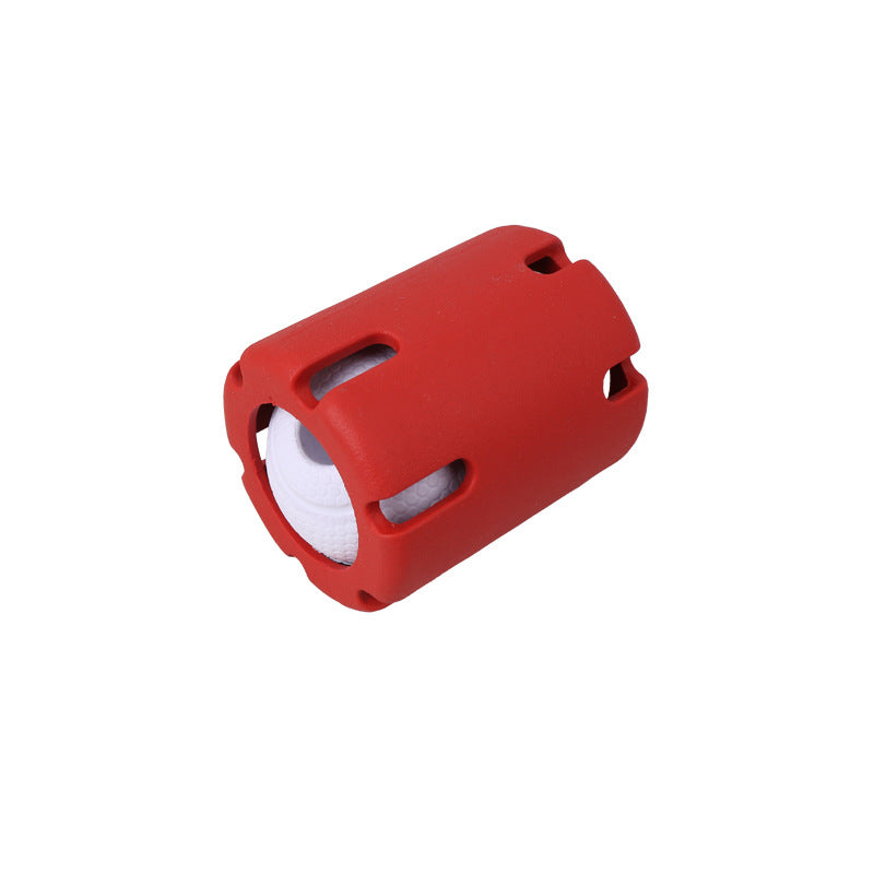 Red slotted rubber dog ball cage holding a white textured ball
