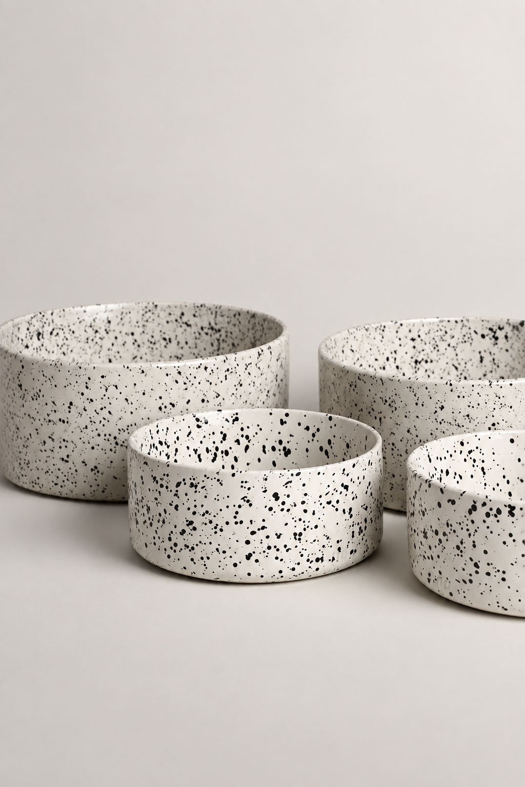 Four speckled bowls studio image