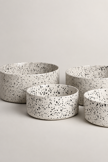 Four speckled bowls studio image