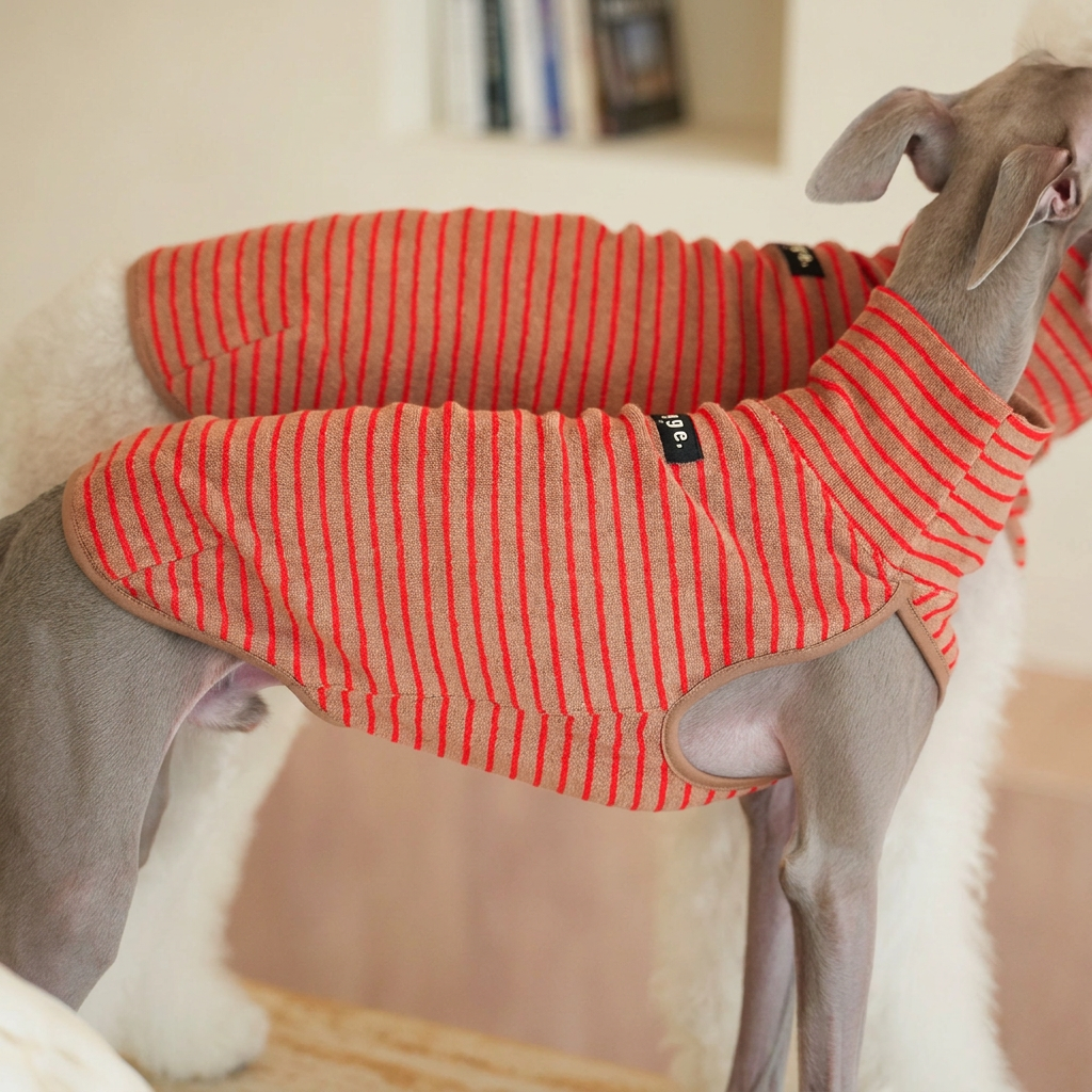 Close-up of brown and red-striped Autumn Stripes dog fleece vests, showing fabric texture, high collars, sleeveless openings and sewn Egge labels.
