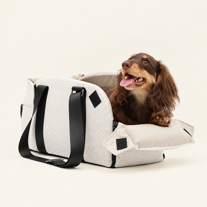 Dog in a cream carrier bed with the front panel open