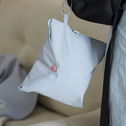 Pale Blue pouch shown with the Quickwear coat, featuring a pink snap button and metal clip; pouch inclusion is unconfirmed.