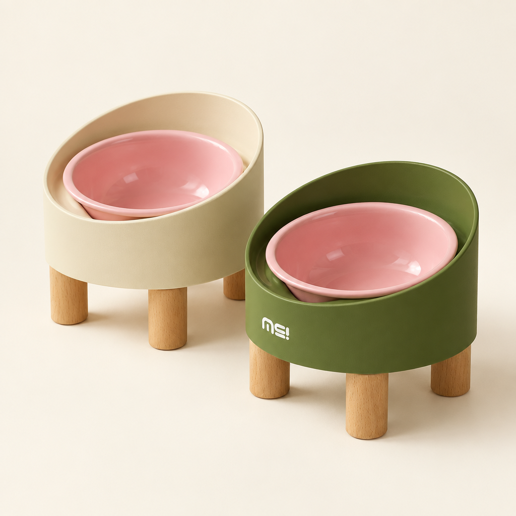 Cream and green raised pet bowls with wooden legs on an off-white background